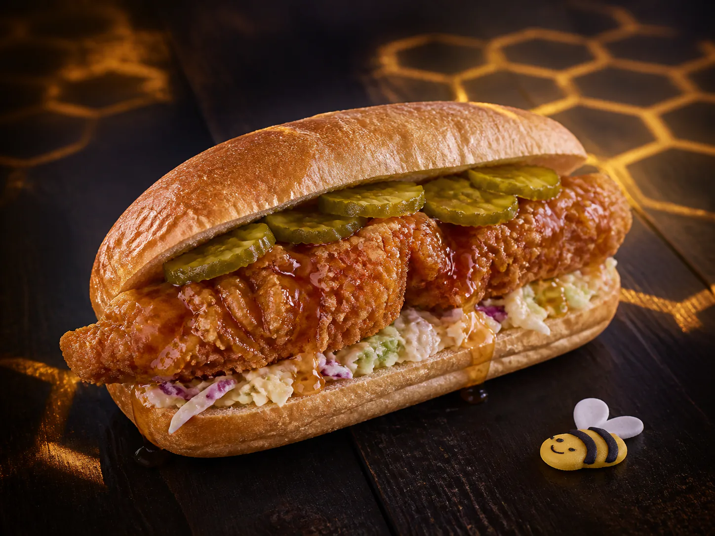 Honey-glazed fried chicken po'boy in amber honeycomb light